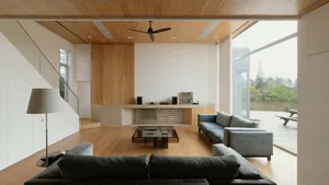 A modern living room featuring wooden walls and furniture.