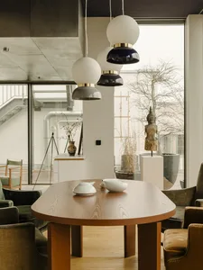 A modern interior design featuring wooden furniture and a unique lighting fixture.