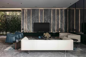 A modern living room with marble accents and a minimalist design.