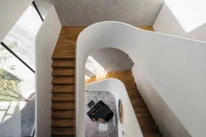 Modern staircase with concrete and wooden stairs and railings