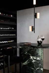 A minimalist bar with a marble countertop and modern lighting fixtures.