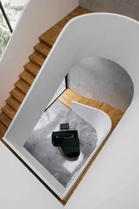 A modern interior design featuring wood, marble, and concrete materials, showcasing a floor plan.