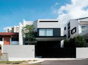 A modern residential home featuring concrete exterior walls and a sleek, minimalist design.