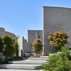 Modern building exterior featuring concrete structure and green plants