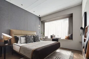 A modern bedroom featuring a bed with fabric upholstery, wooden headboard, and metal accents, situated next to a window with 