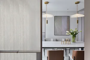 A modern dining room featuring marble surfaces and leather chairs.