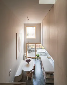 A minimalist dining room featuring modern materials and furniture.