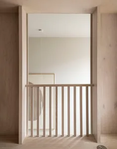 A minimalist interior design featuring light-colored wooden elements.