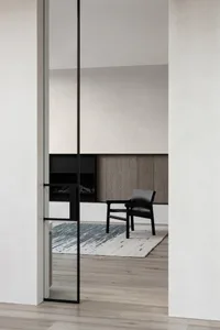Modern minimalist interior design featuring a wooden chair and a textured rug.