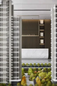 A view of a modern office space featuring marble paneling and wooden accents.