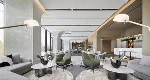 A modern lobby features gray sofas, green armchairs, white marble tables, and white lighting with organic furniture and concr