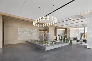 A modern lobby interior with a concrete architectural model.