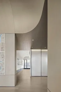 Modern office setting with a metal ceiling and hallway view