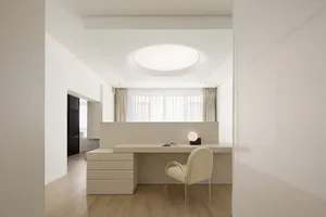 Modern minimalist residential interior design featuring a concrete countertop and white furniture.