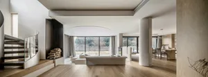 Modern minimalist living room featuring concrete, glass, and wooden elements.