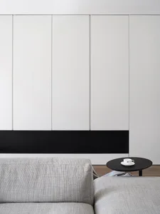A minimalist living room featuring a gray sofa in a contemporary design setting.
