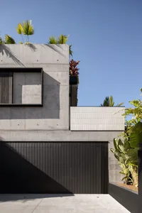 Modern building with concrete exterior and green top garden