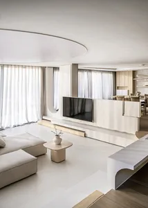 Modern minimalist living room featuring marble and wood elements.
