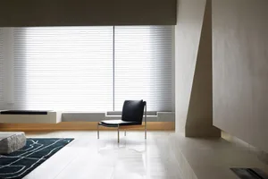 Modern living room with white marble flooring and minimalist decor.