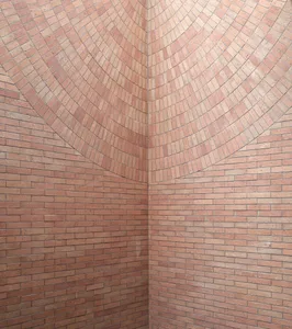 A textured brick wall featuring a circular pattern.