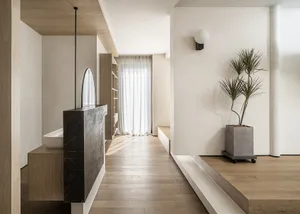 Modern bathroom featuring concrete countertop, glass enclosure, and wood accents.