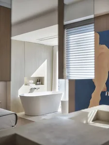 Modern bathroom featuring a minimalist design with concrete elements.