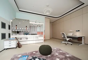 A modern child room with a white bunk bed, study area, and decorative elements.