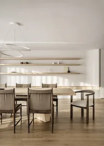 Modern minimalist dining room featuring wood furniture and clean lines.