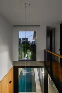 Modern interior design featuring glass walls, industrial lighting, and concrete flooring.
