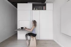 A modern office space with a metal desk and industrial design elements.