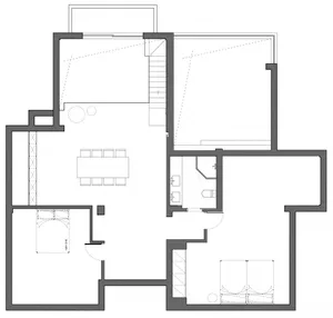 A modern architecture floor plan with a central open space, staircase, and two bedrooms.