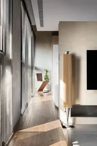 Modern minimalist living room with wooden furniture and flooring.