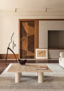 A minimalist living room with wooden elements and a central coffee table.