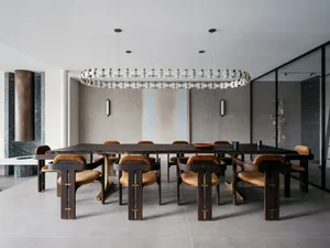 Contemporary dining room featuring wooden furniture, minimalist design, and a circular chandelier.
