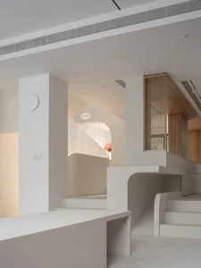 A modern interior space with minimalist design, featuring exposed concrete walls and floors.