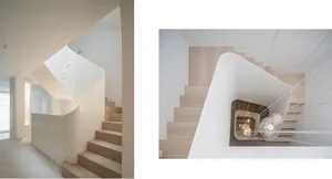 Modern, minimalist interior with wooden stairs and minimalist lighting.