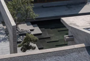 Modern outdoor space featuring a concrete and glass architectural plan with a pool and trees.
