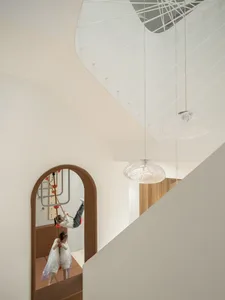 Modern playroom with wooden elements and children enjoying activities.