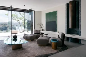 A modern living room featuring marble and glass elements.