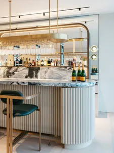 Modern bar counter featuring marble surface and contemporary design.