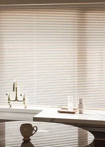A modern minimalist kitchen featuring marble countertops and a sleek, sophisticated design.
