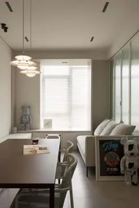 Modern minimalist living room featuring white furniture, white blinds, and white light fixtures.