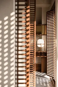 A modern retro lamp with a wooden frame, positioned in a minimalist setting with light-colored walls and a wooden floor.
