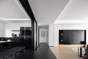Modern interior space with white walls, black flooring, and black materials.