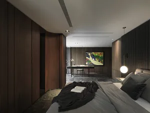 A modern bedroom featuring wooden walls, a grey bed, and a light fixture