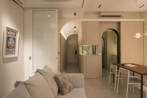 A modern, minimalist living room with neutral-toned furniture and decor.