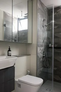 Modern residential bathroom featuring gray marble tiles and a sleek, contemporary design.