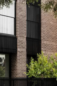 Modern brick building exterior with black window frames