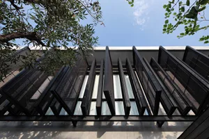 Modern building exterior featuring black metallic structural elements