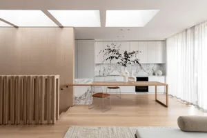Modern minimalist kitchen featuring wooden flooring, marble countertops, and sleek white cabinetry, designed for elegant and 